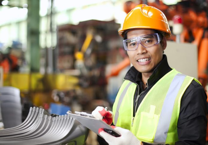 Portrait of young engineer taking notes
